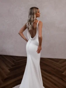 Model wearing Austin bridal gown by Made With Love (full back view).