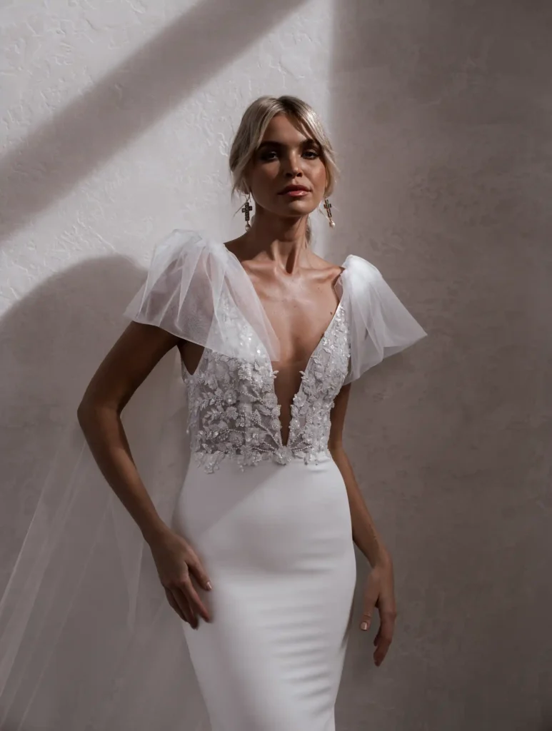 Model wearing Cameron Crepe With Wings bridal gown by Made With Love bridal dresses (front view)