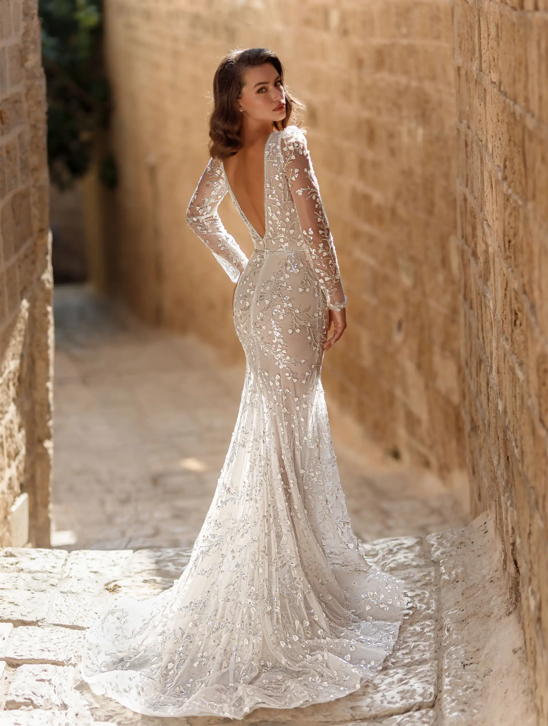 Model wearing Brooke bridal gown by Adi Shlomo Bridal, full back view