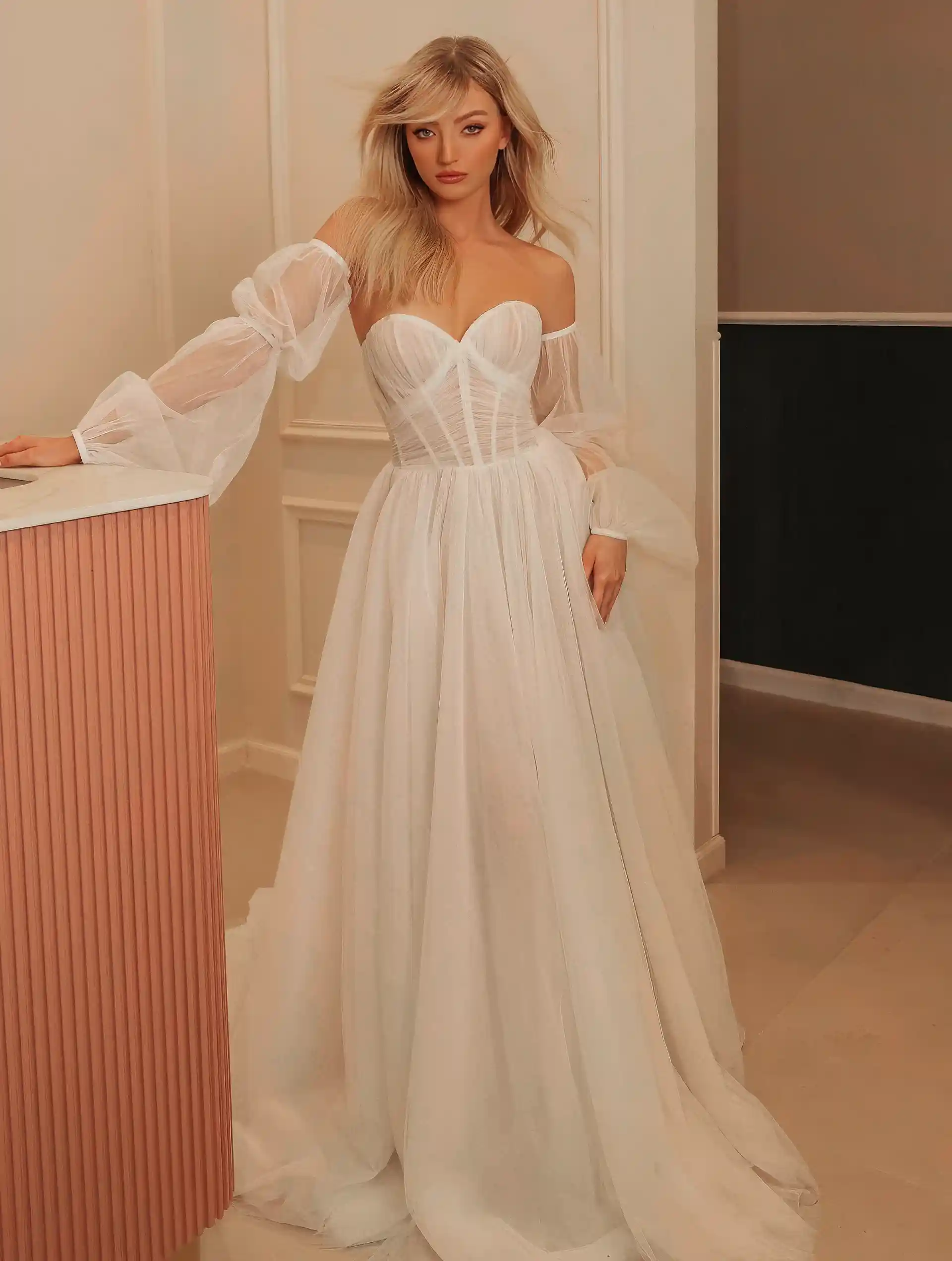 Model wearing Christine gown by La Premiere Bridal full front view with sleeves