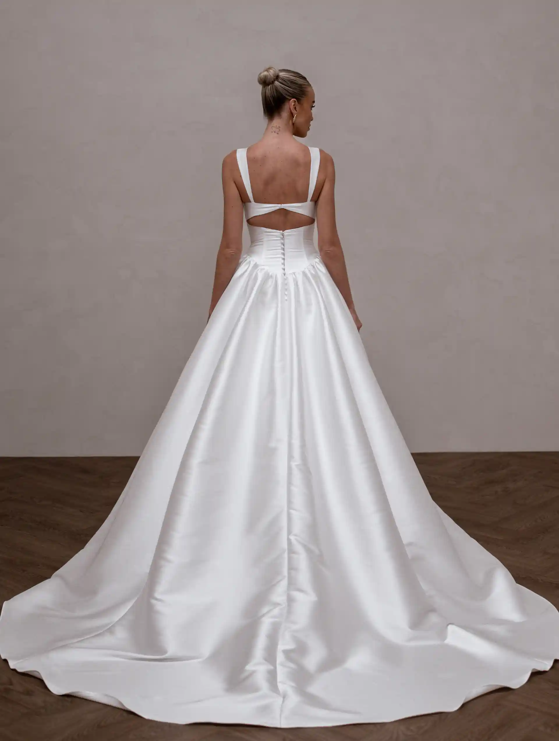 Model wearing Raine by Made With Love bridal gowns full back view